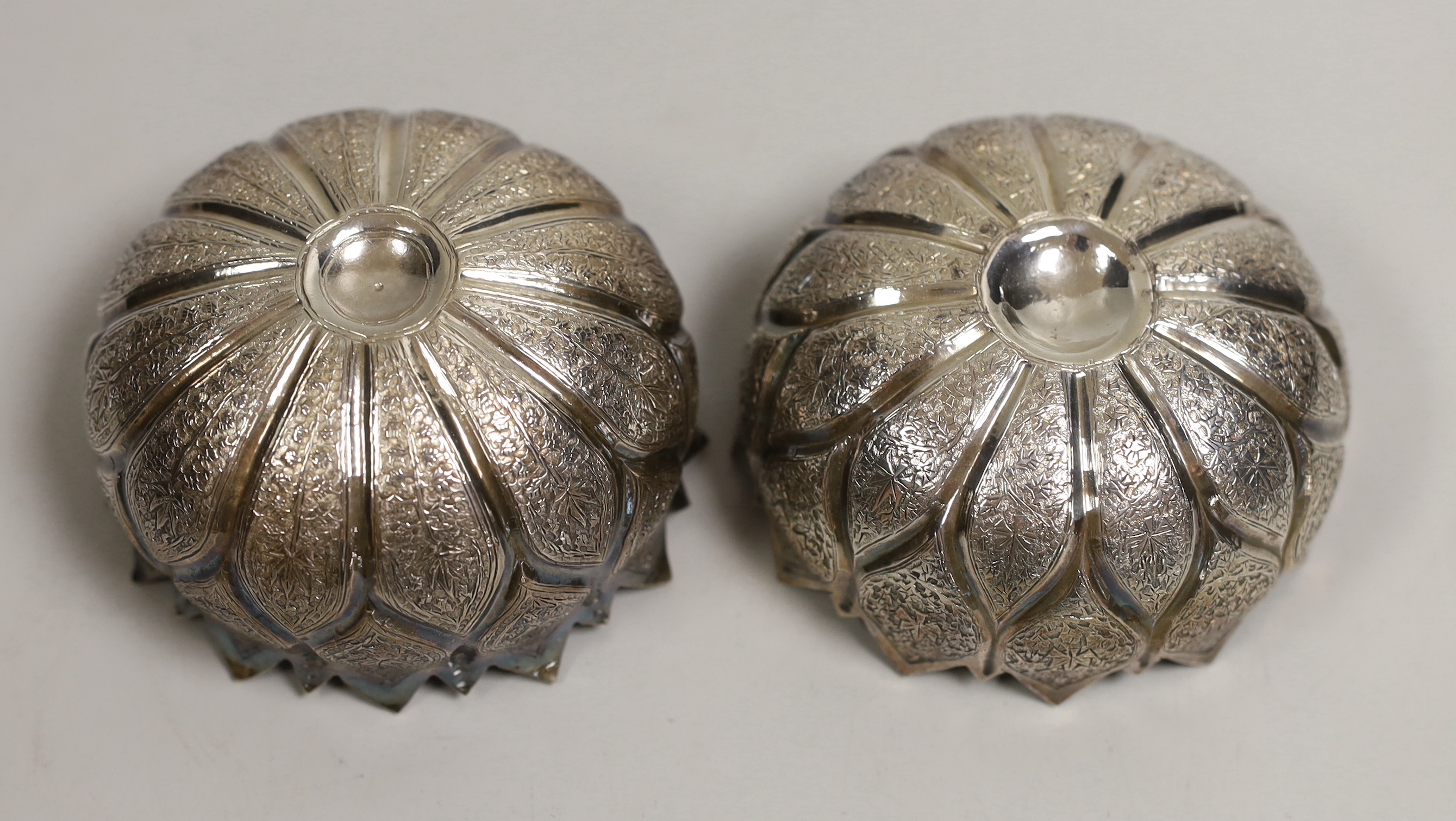 A pair of Indian white metal lotus leaf finger bowls, diameter 8cm, 4.9oz.